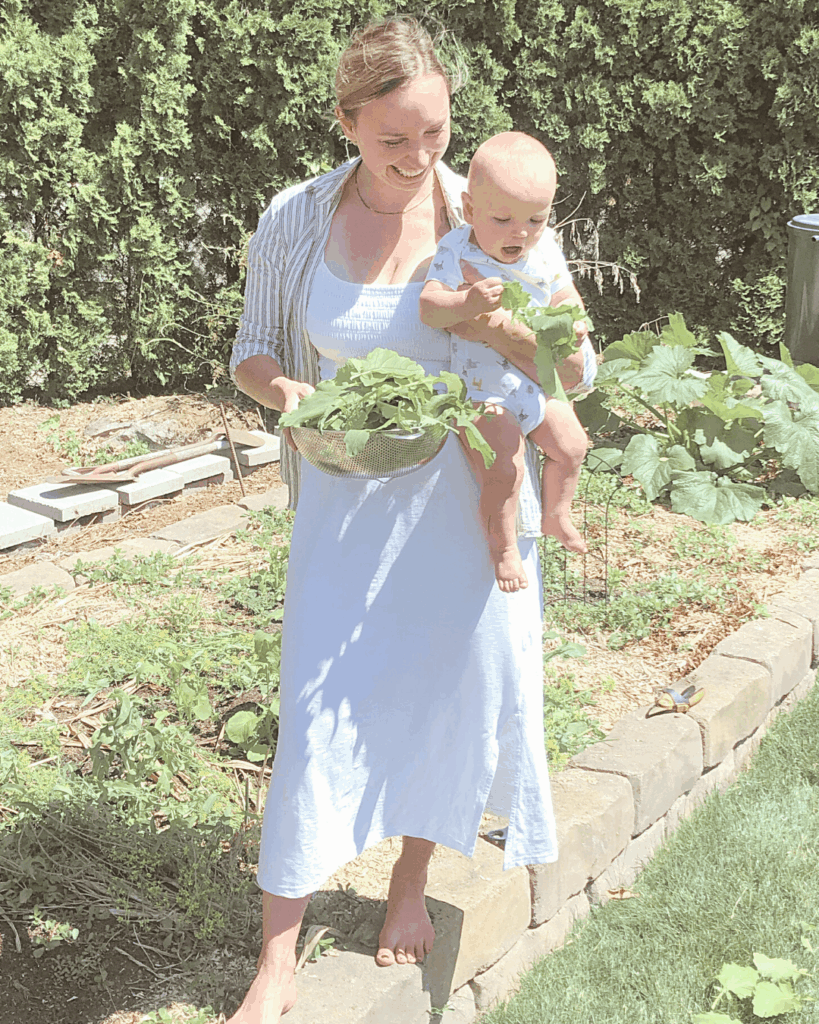 first time mom holding her baby in the garden
