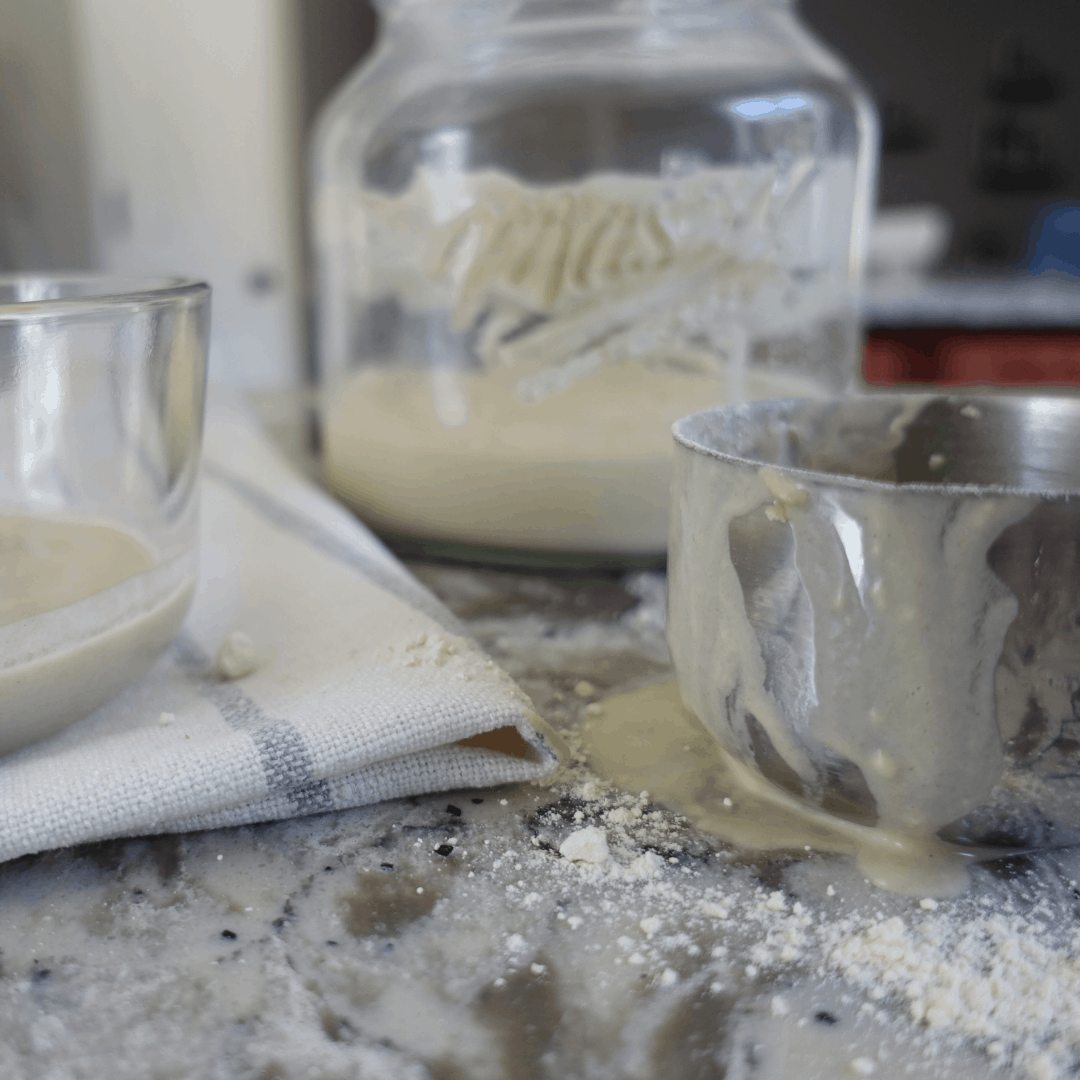 process of making sourdough starter with measuring cup flour and discard
