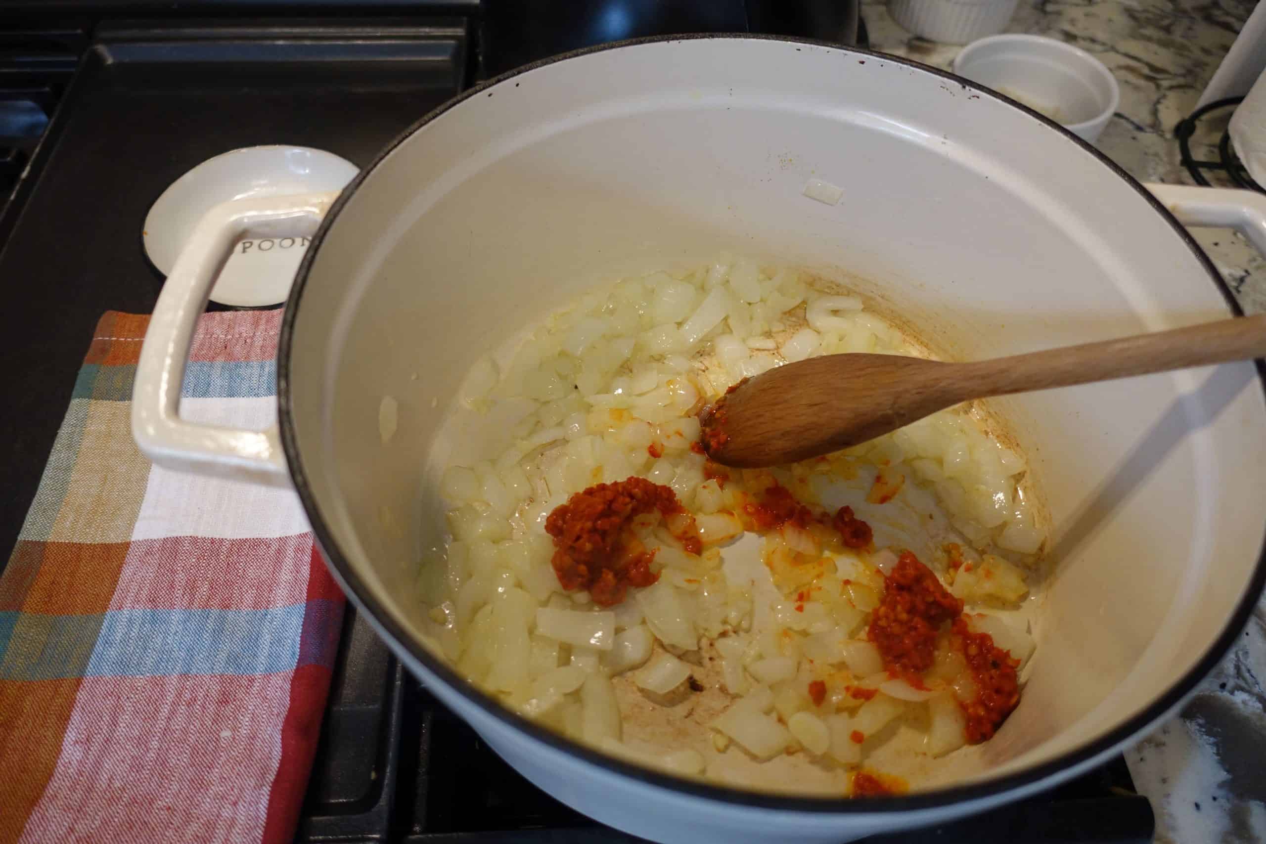 chile paste in sauteed onions in large white dutch oven