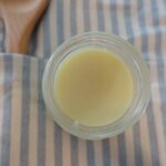 homemade healthfully rooted home wood butter to season wooden spoons on top apron