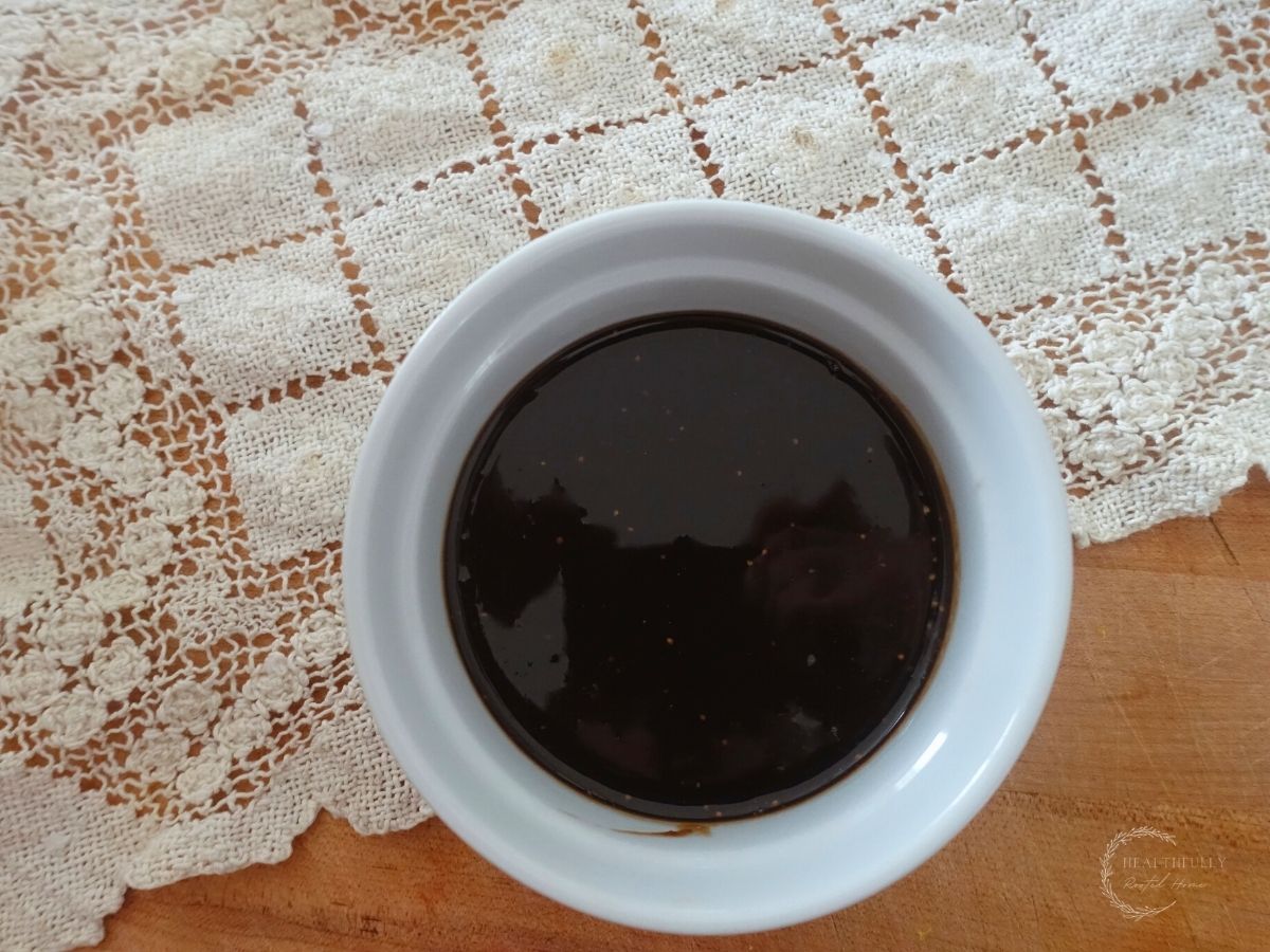 balsamic fig glaze in a white bowl with a lace doily underneath