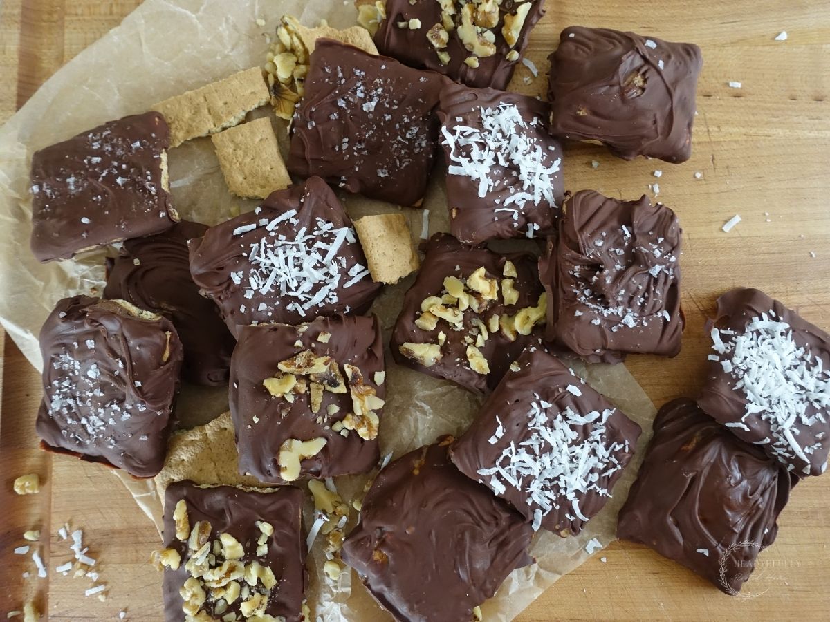 chocolate covered graham crackers on parchment paper with various toppings
