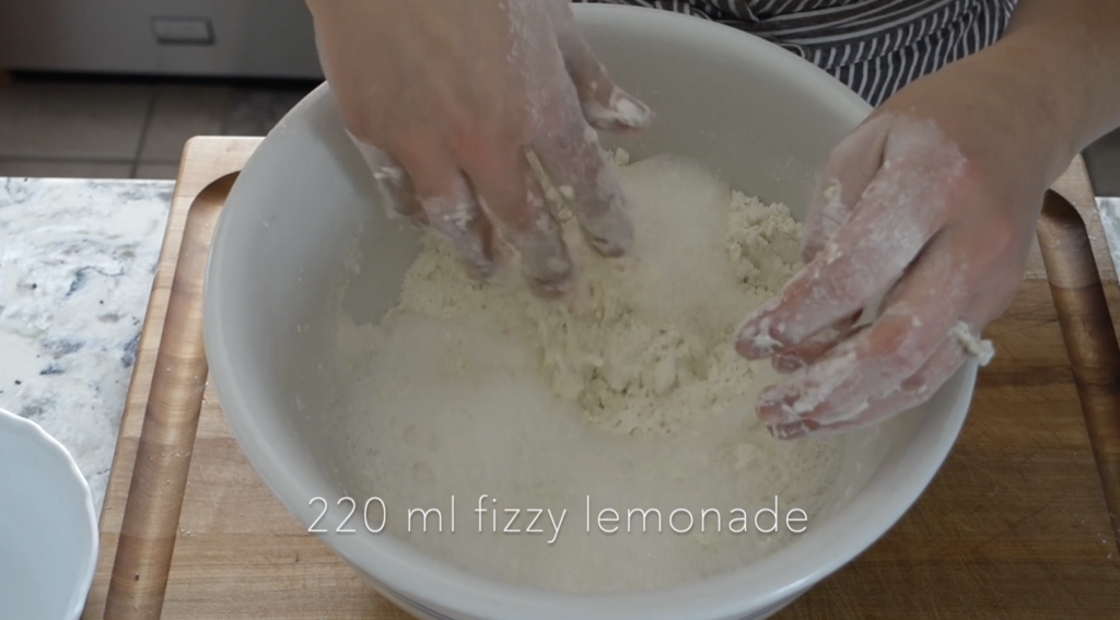 fizzy lemonade poured into the dry mixture for scones and using hands to make the dough