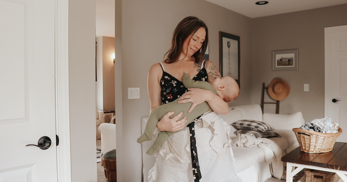 homemaker holding her baby looking him in the eyes and smiling