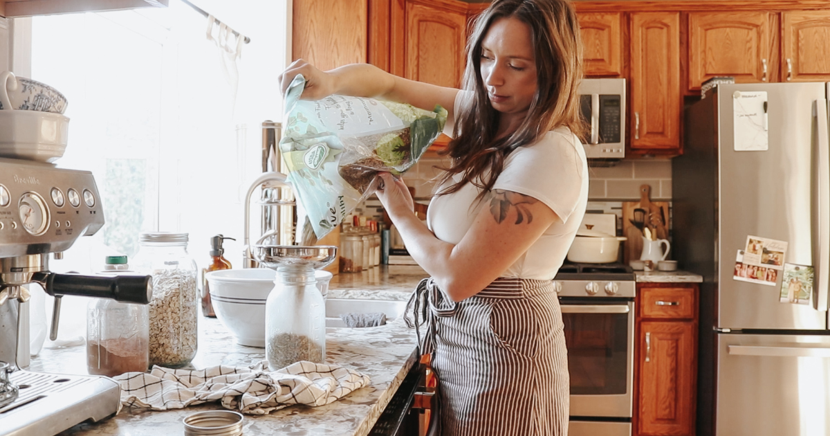 living slowly as a christian homemaker shes making food in her kitchen in a skirt