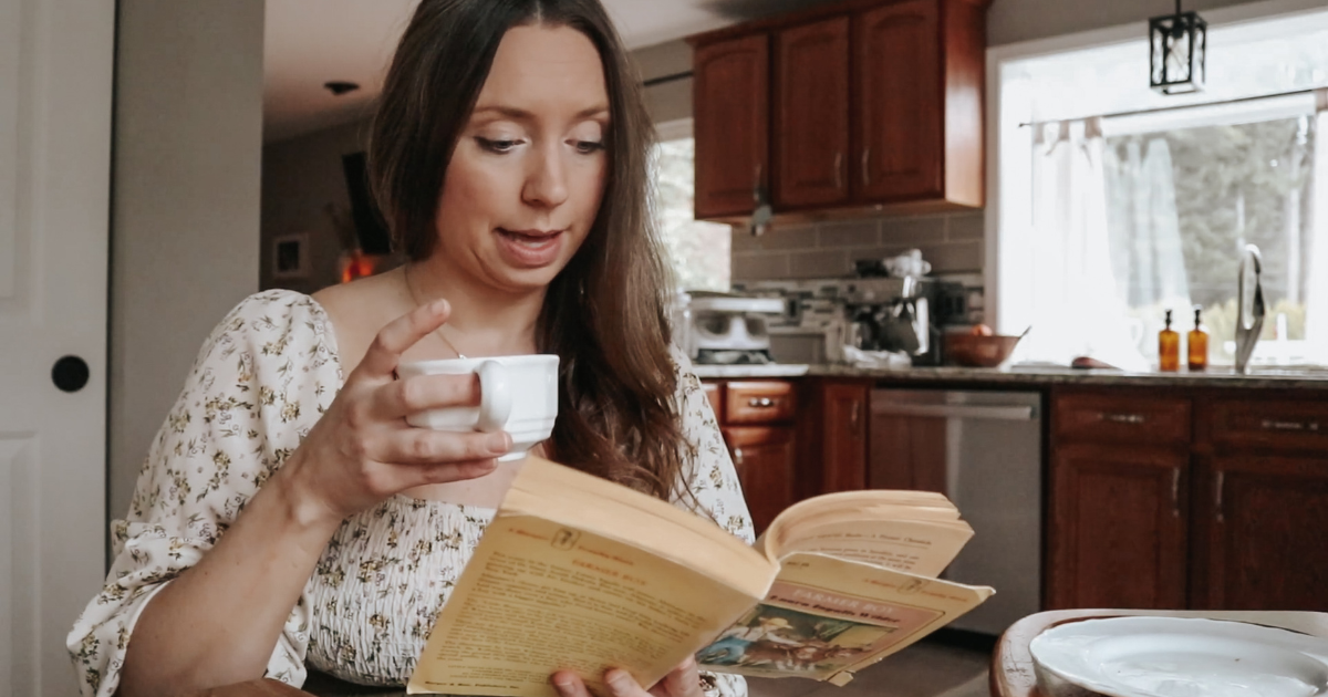 homemaker drinking coffee and reading laura ingalls wilder