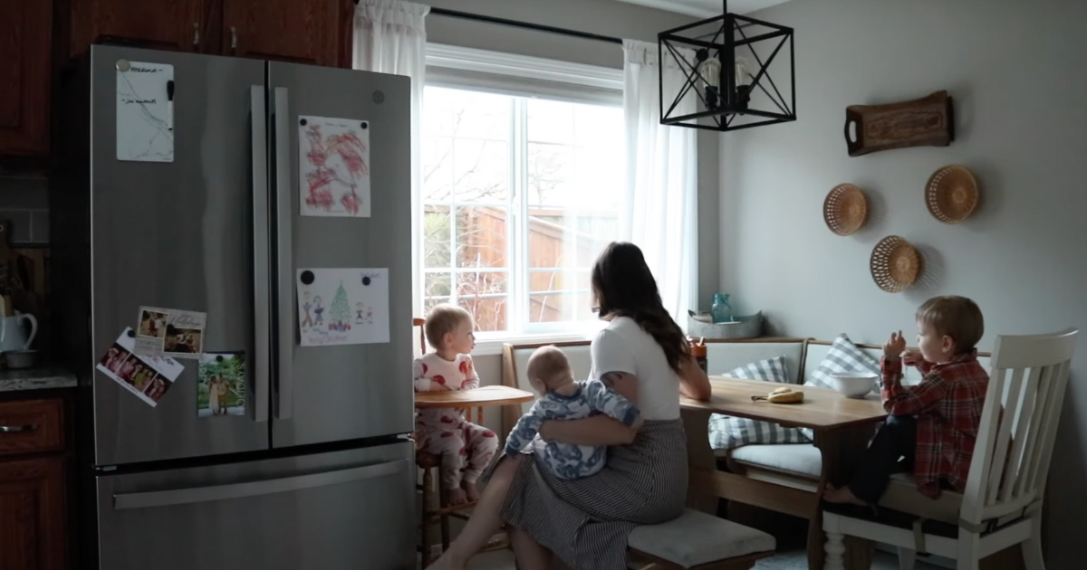 homemaker feeding her toddler sitting in a breakfast nook