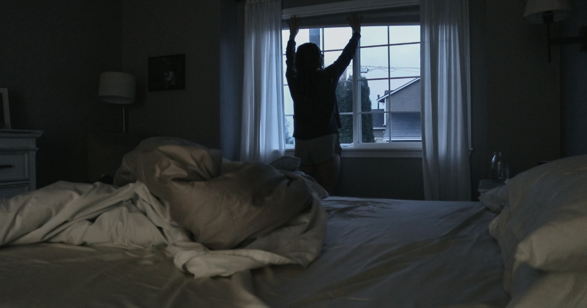 Homemaker opens the windows in the early morning to let the light in