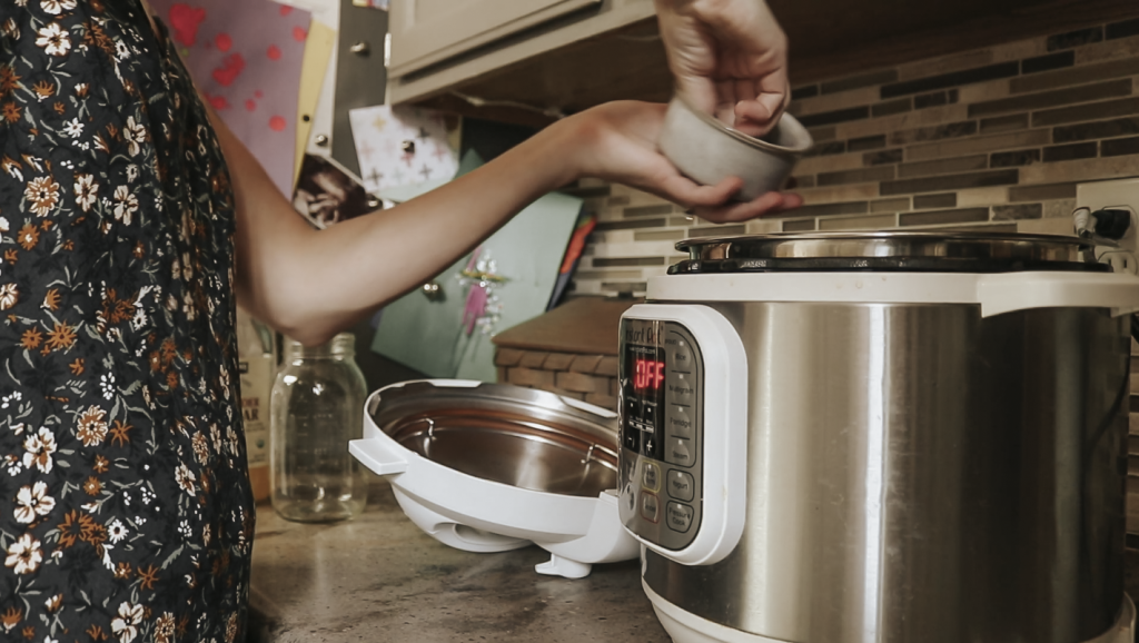 Christian homemaker places ingredients into her instant pot.