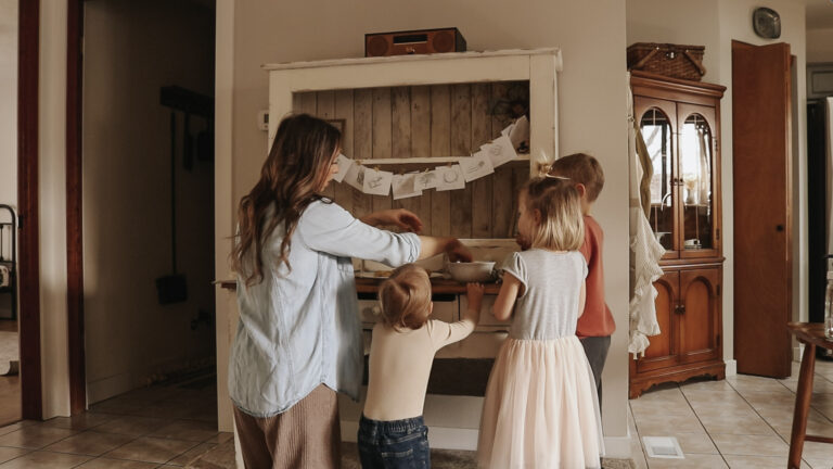 Christian mother and homemaker stands with her three children and makes cookies.