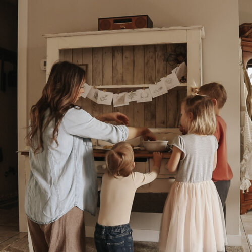 Christian mother and homemaker stands with her three children and makes cookies.