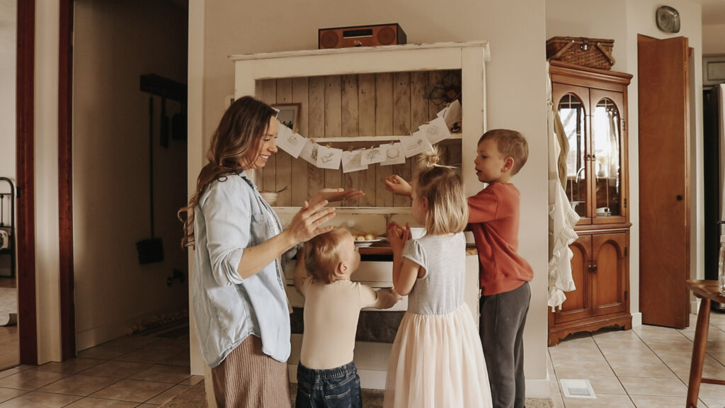 Christian mother and homemaker stands with her three children and makes cookies.