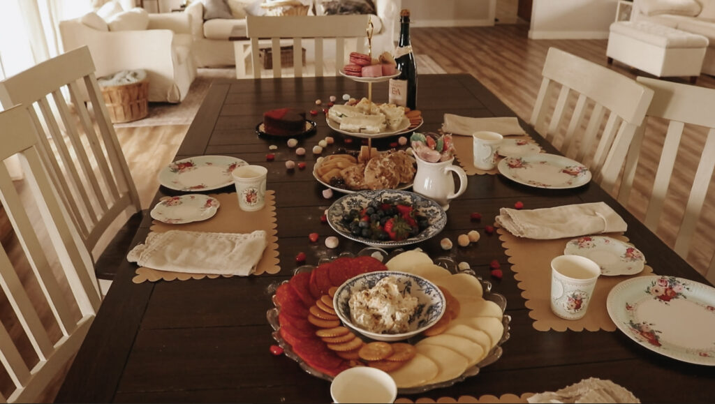 Dining room table is covered with snacks and decorations.