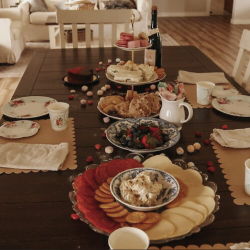 Dining room table is covered with snacks and decorations.