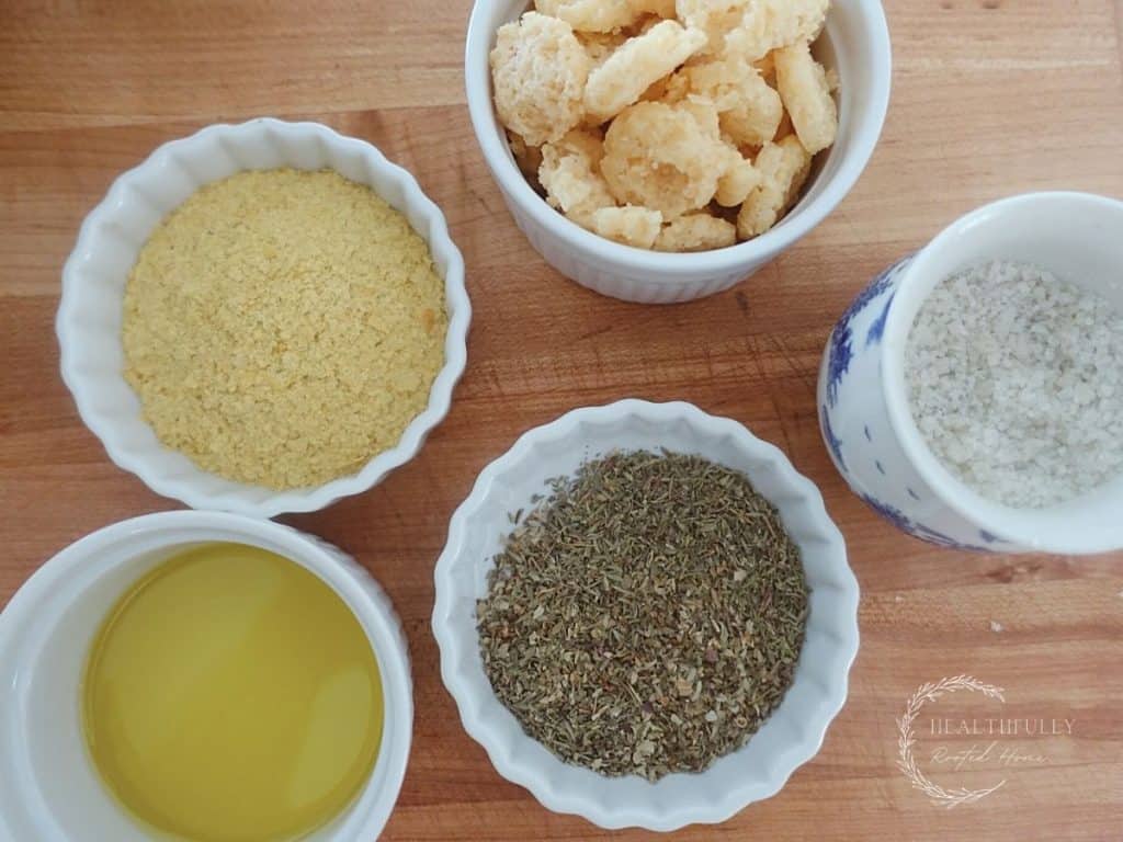 cheese crisps nutritional yeast, herbs, se salt and olive oil in white glass jars