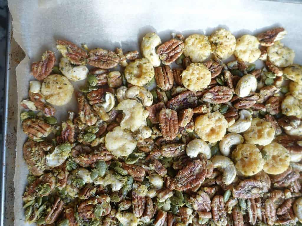 savory trail mix on a parchment lined baking sheet
