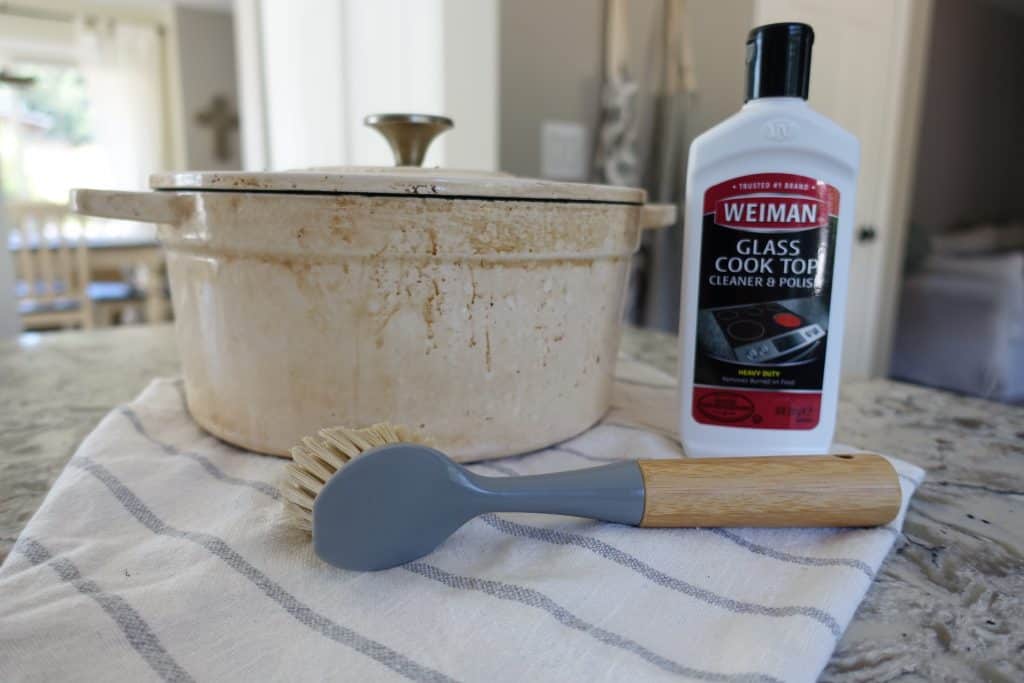 burnt white dutch oven with scrub brush and weiman glass cooktop cleaner