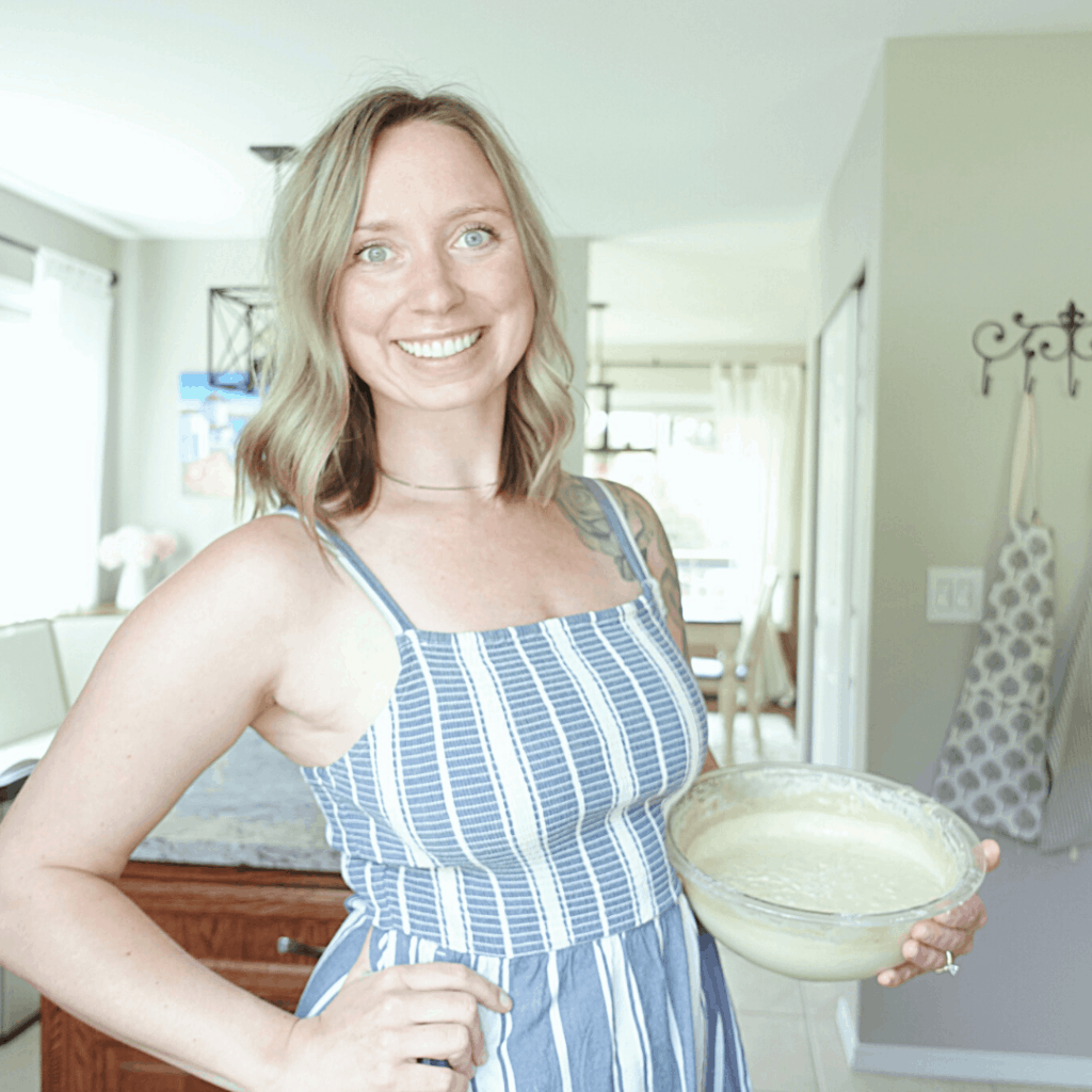 einkorn flour sourdough starter healthfully rooted home holding bowl of sourdough starter in blue dress