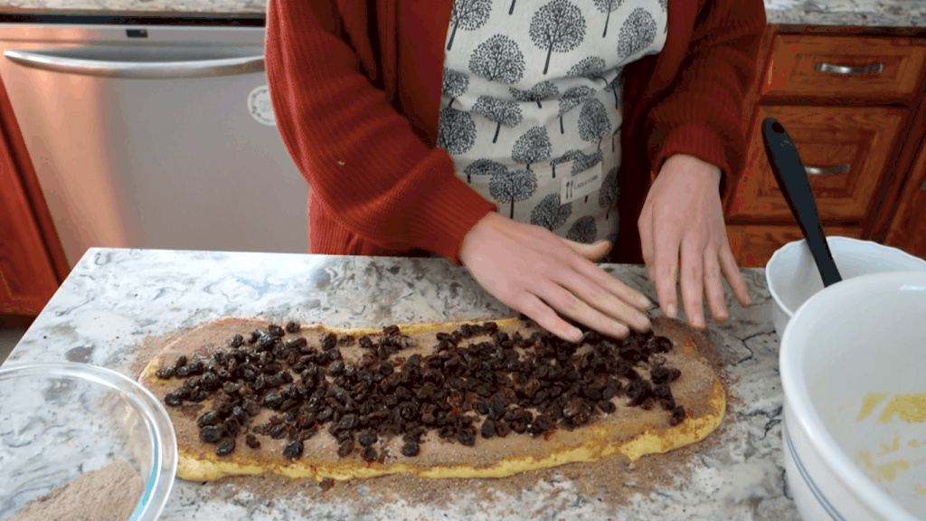 placing the raisins on top of the cardamom filling 