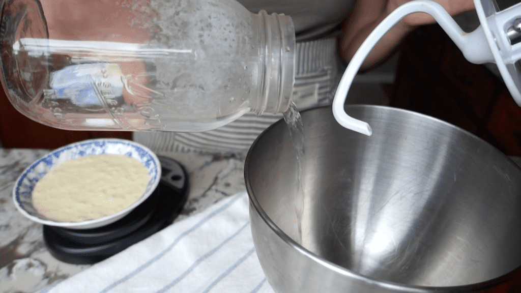 adding boiling water to bowl of a kitchenaid stand mixer