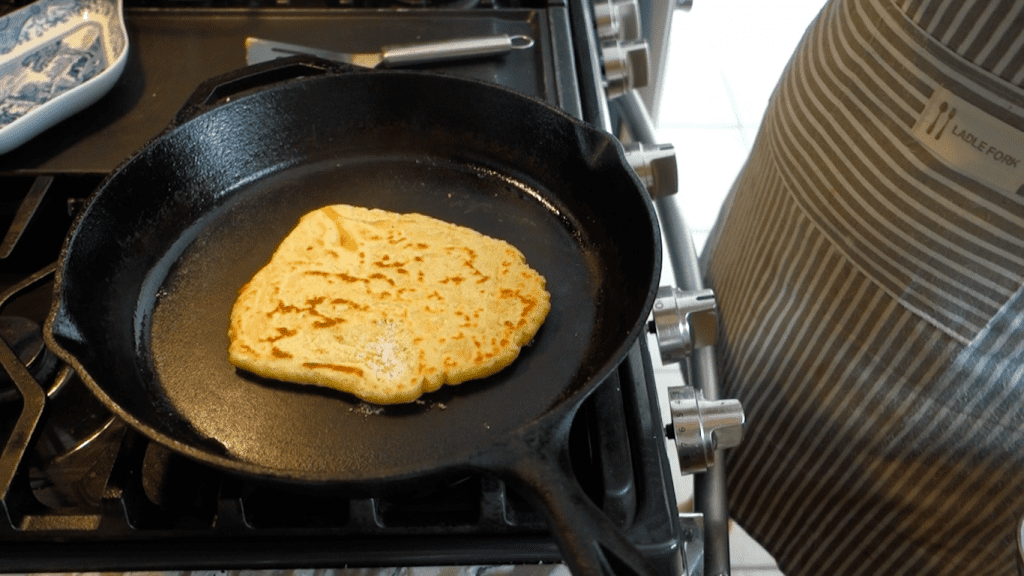 spotty brown einkorn tortilla in a lodge cast iron skillet