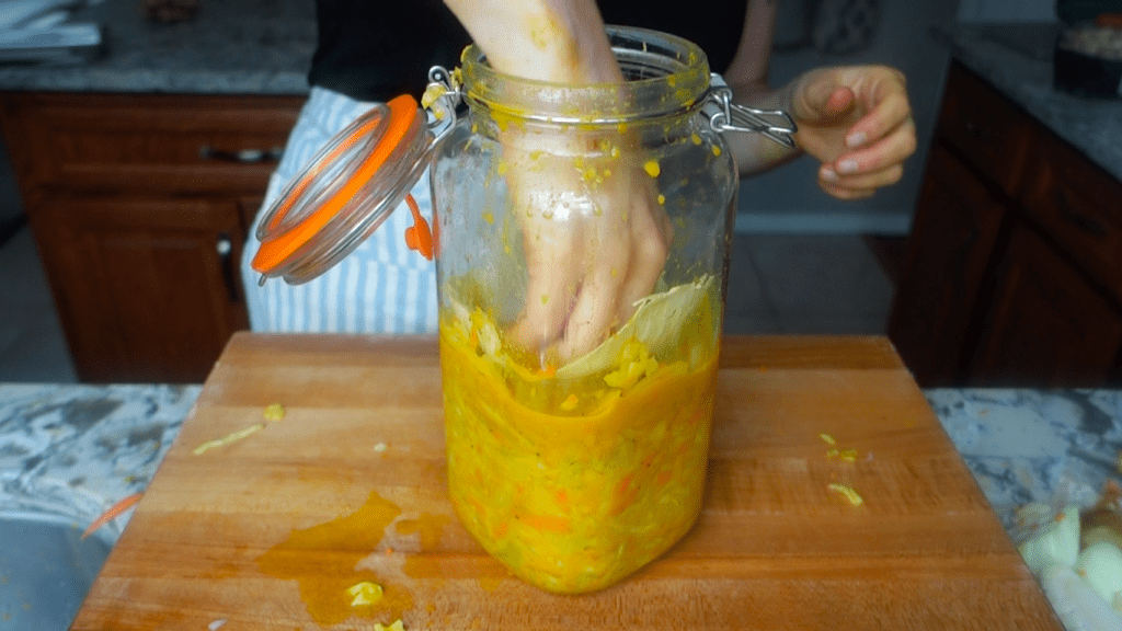 placing the spare organic cabbage leaves on top of the curry kraut