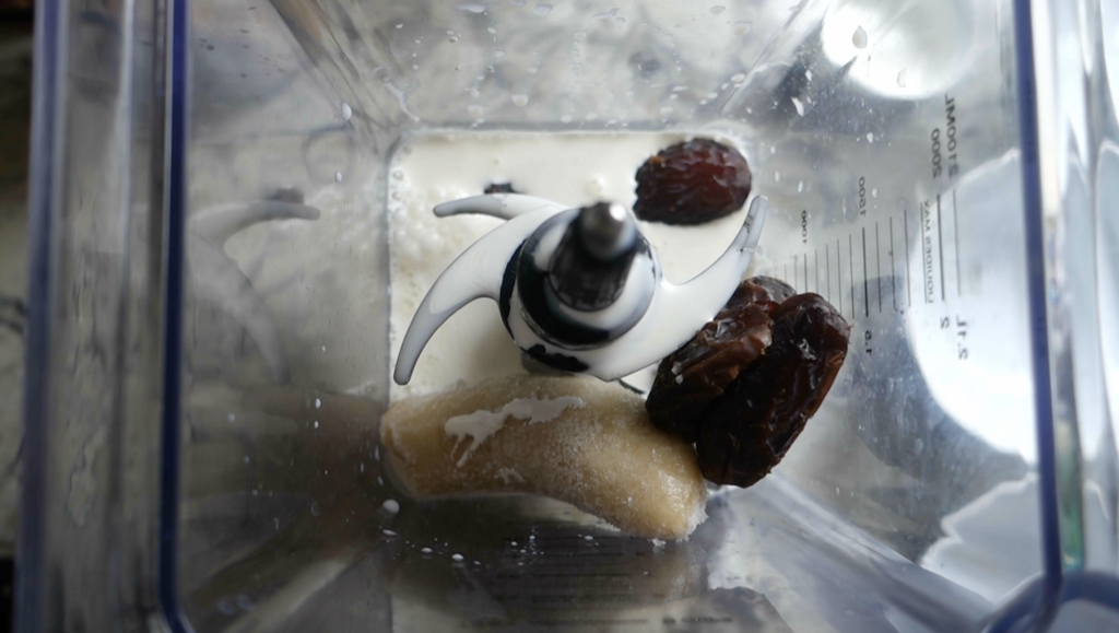 ingredients to make a dates milkshake in a high powered blender ready to blend into a shake