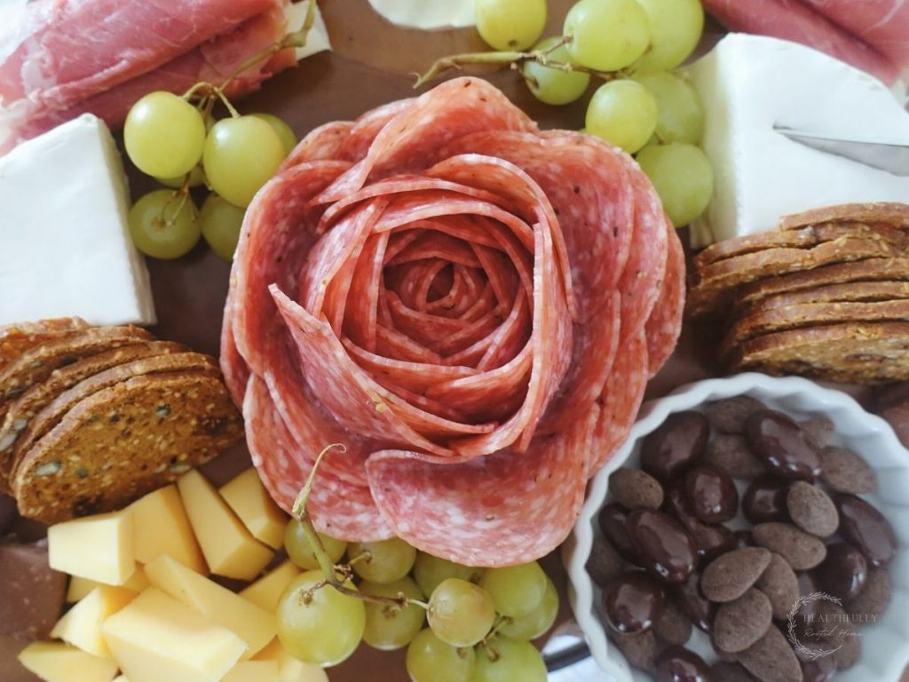 small charcuterie board with all the adornments and a cheese knife inside the brie
