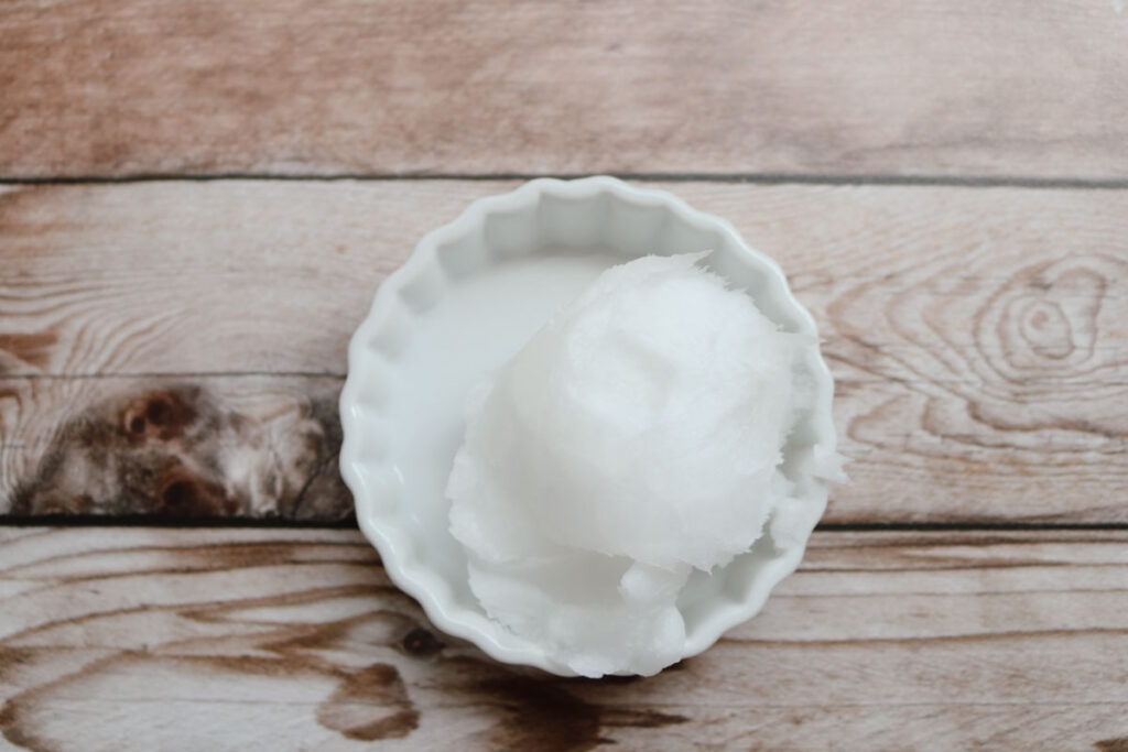 jar with coconut oil on a wooden background