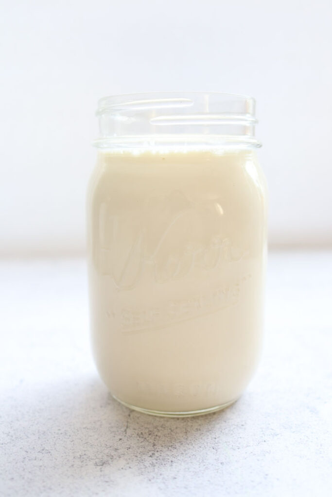 mason jar filled with buttermilk shown as an alternative to applesauce in recipes