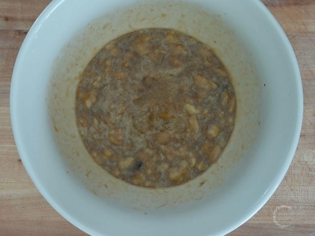 bananas mixed into the sugar butter mixture for banana blueberry oatmeal muffins