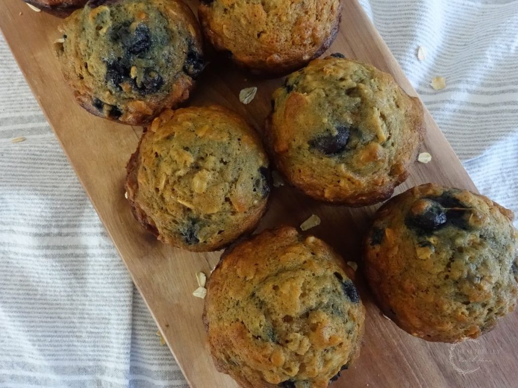 batch of banana muffins on a wooden platter