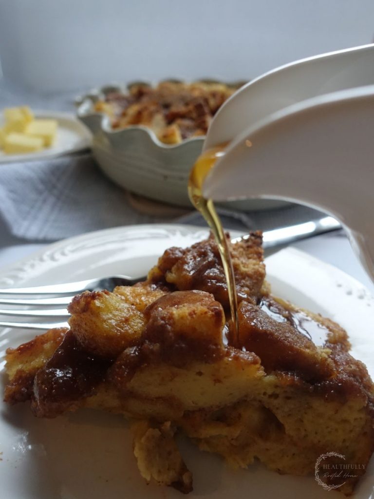 slice of brioche french toast casserole with syrup being poured overtop