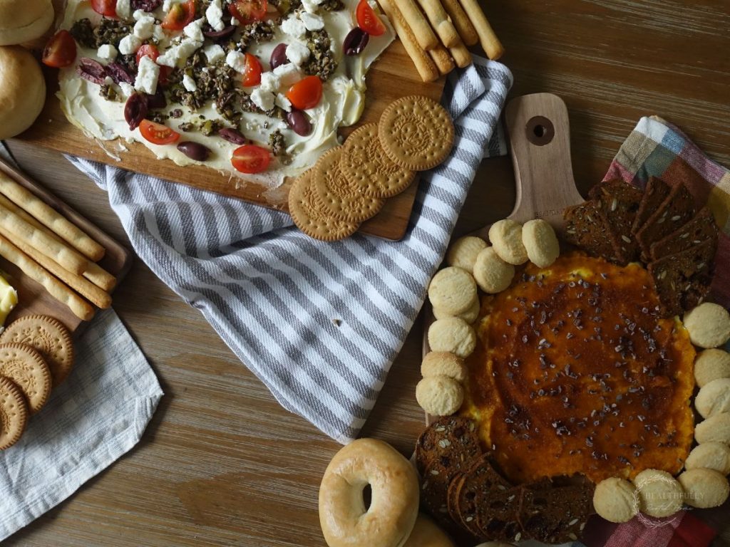 greek style butter board with a pumpkin spice butter board next to it
