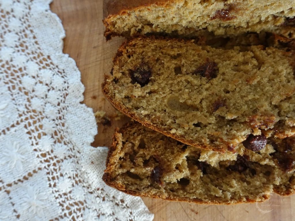 sourdough discard banana bread slices with a lace doily next to them