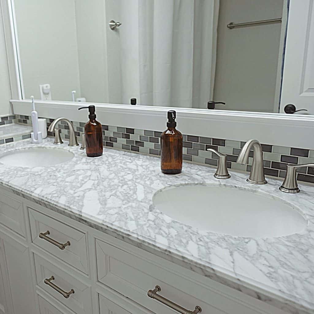 declutter your home in 30 days bathroom with grey granite and subway tile and amber soap jars