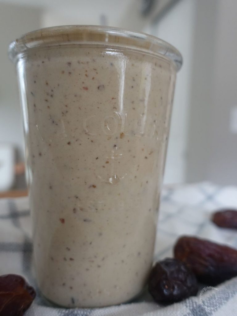 dates milkshake on a tea towel with dates surrounding it