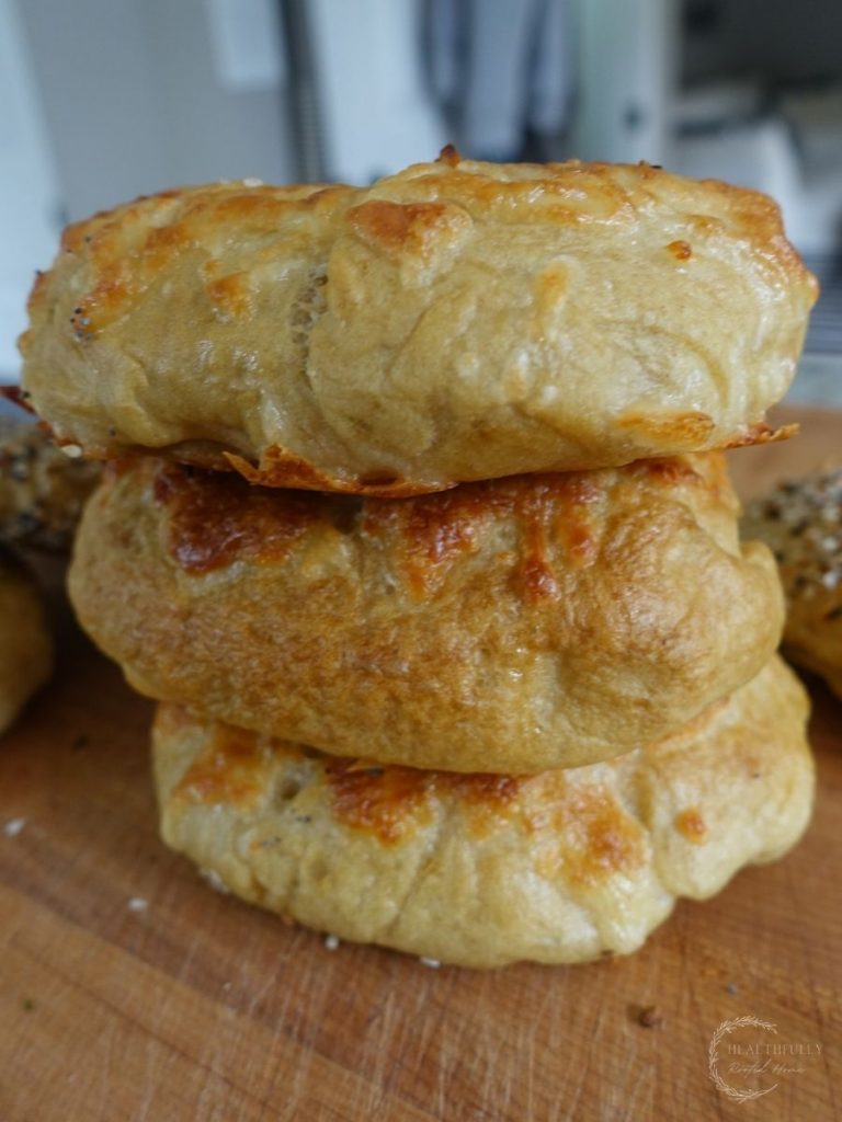 three sourdough discard bagels stacked on top of eachother