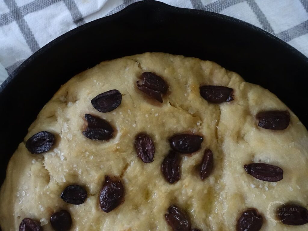 close up of a focaccia loaf in a cast iron skillet