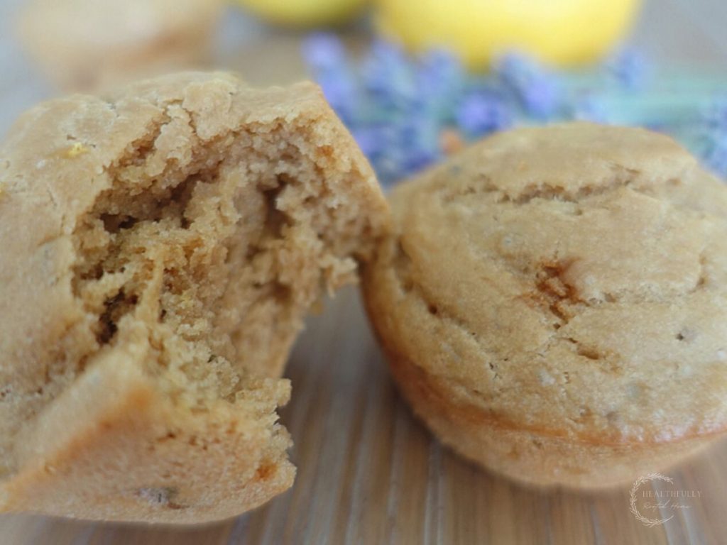 lemon and lavender sourdough discard muffin on top another muffin with a bite taken out