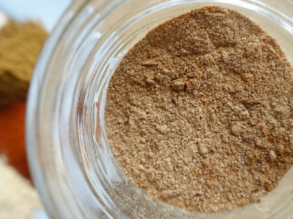 low sodium taco seasoning in a mason jar with more spices in the background