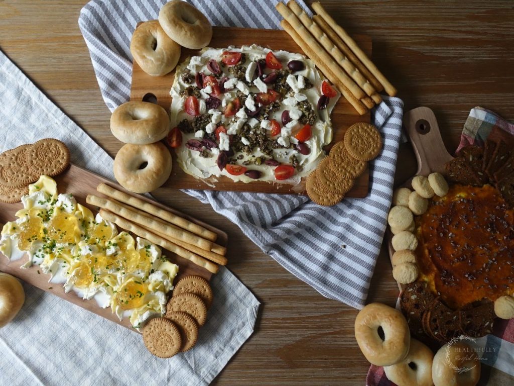 3 butter boards on a table with tea towels underneath