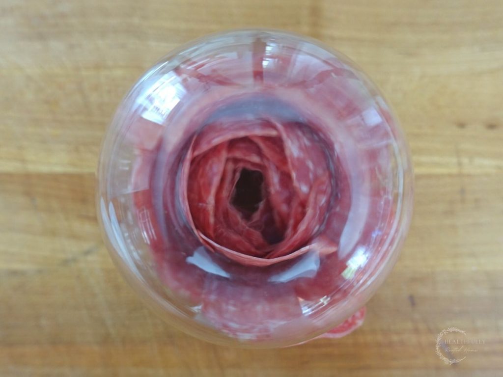 salami rose inside of a wine glass