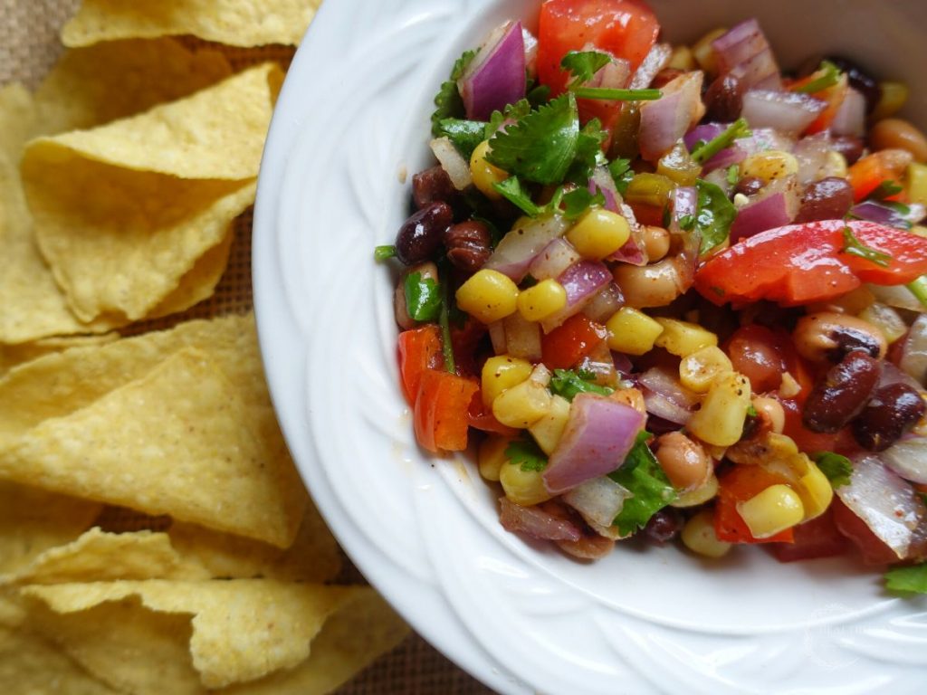 serving mexican caviar with chips inside of a white bowl