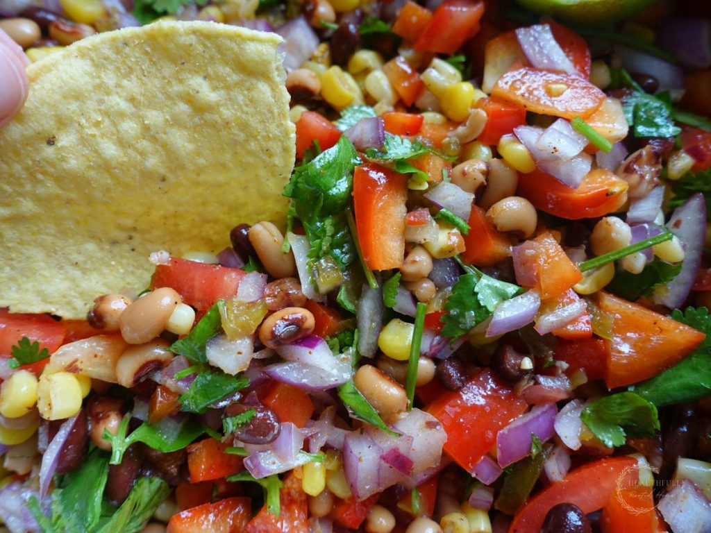 mexican caviar with a chip dipped inside the dip