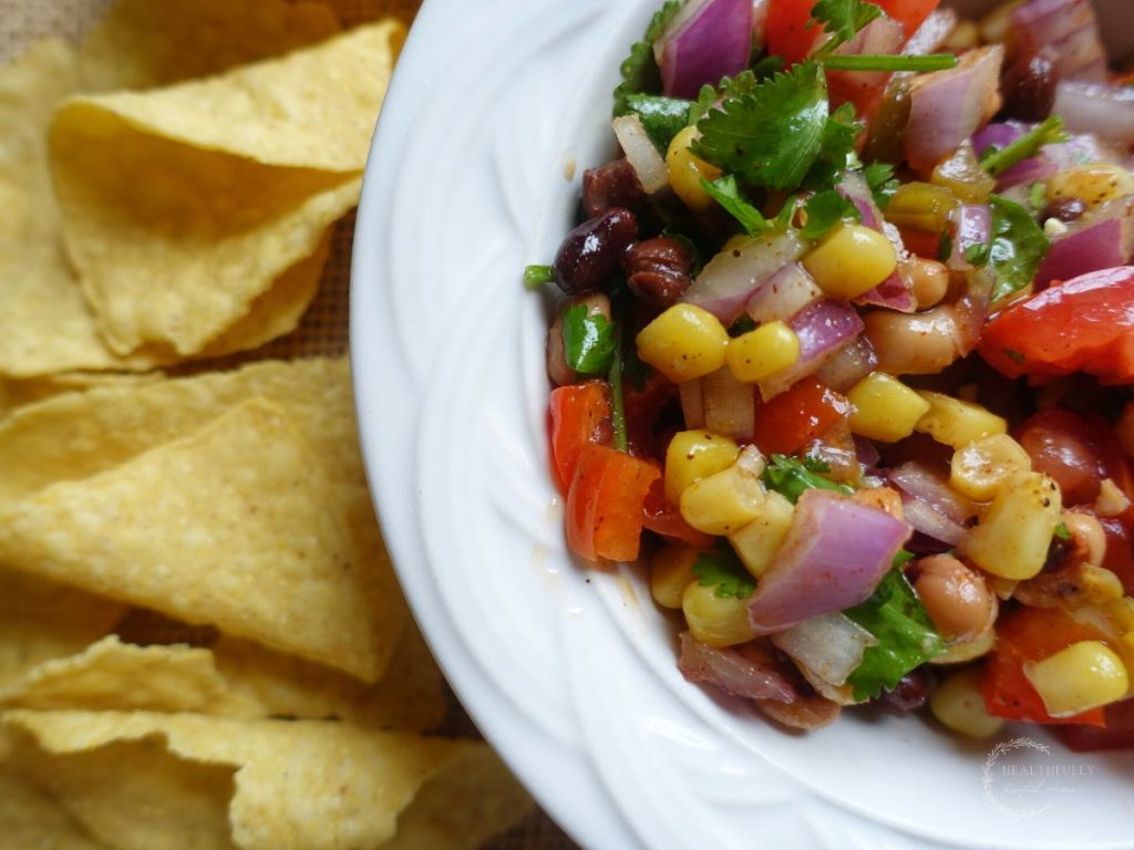 mexican caviar in a white serving bowl with a side of chips
