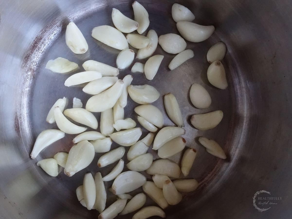 garlic cloves inside of a sauce pan
