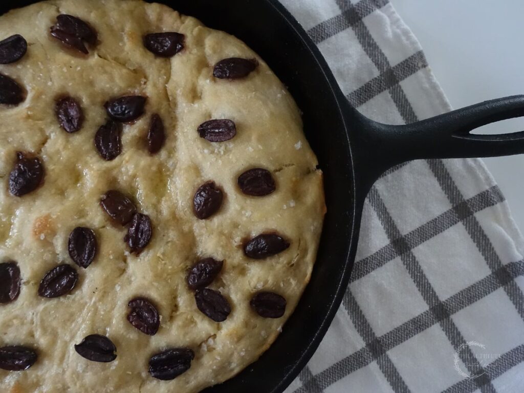 sourdough discard focaccia baked with a crispy crust in a cast iron skillet