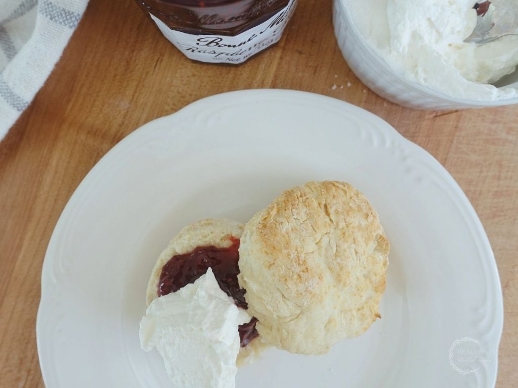 top view of lemonade scones no cream topped with jam and whipped cream