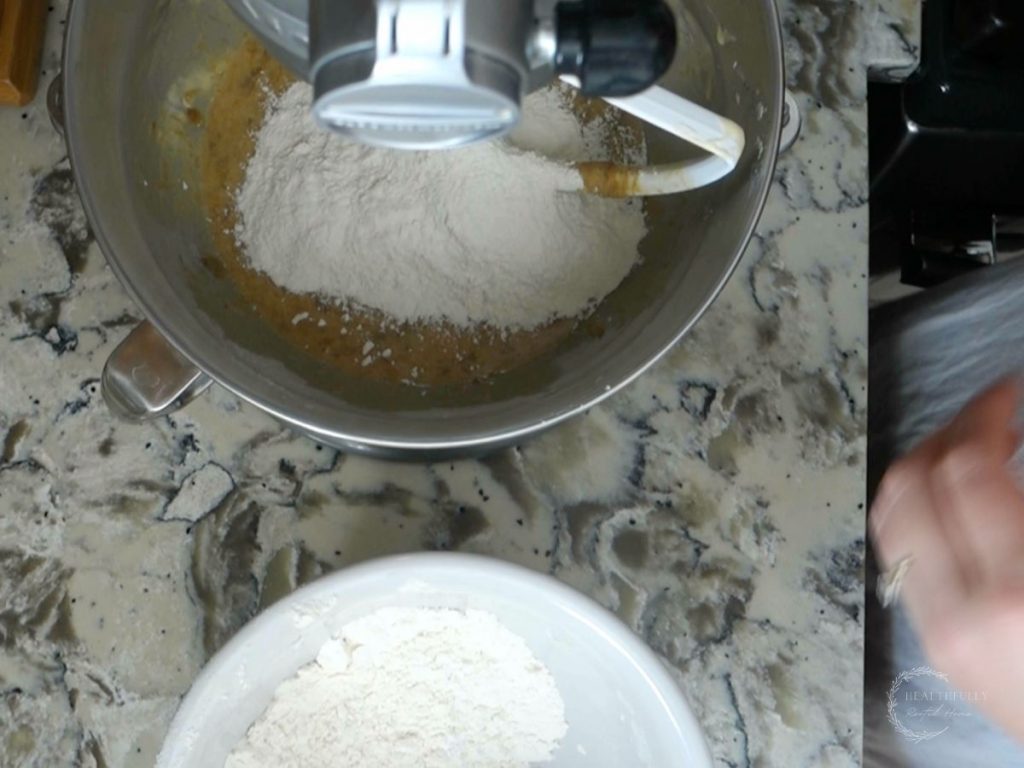 adding the dry mixture to the wet mixture in a stand mixer